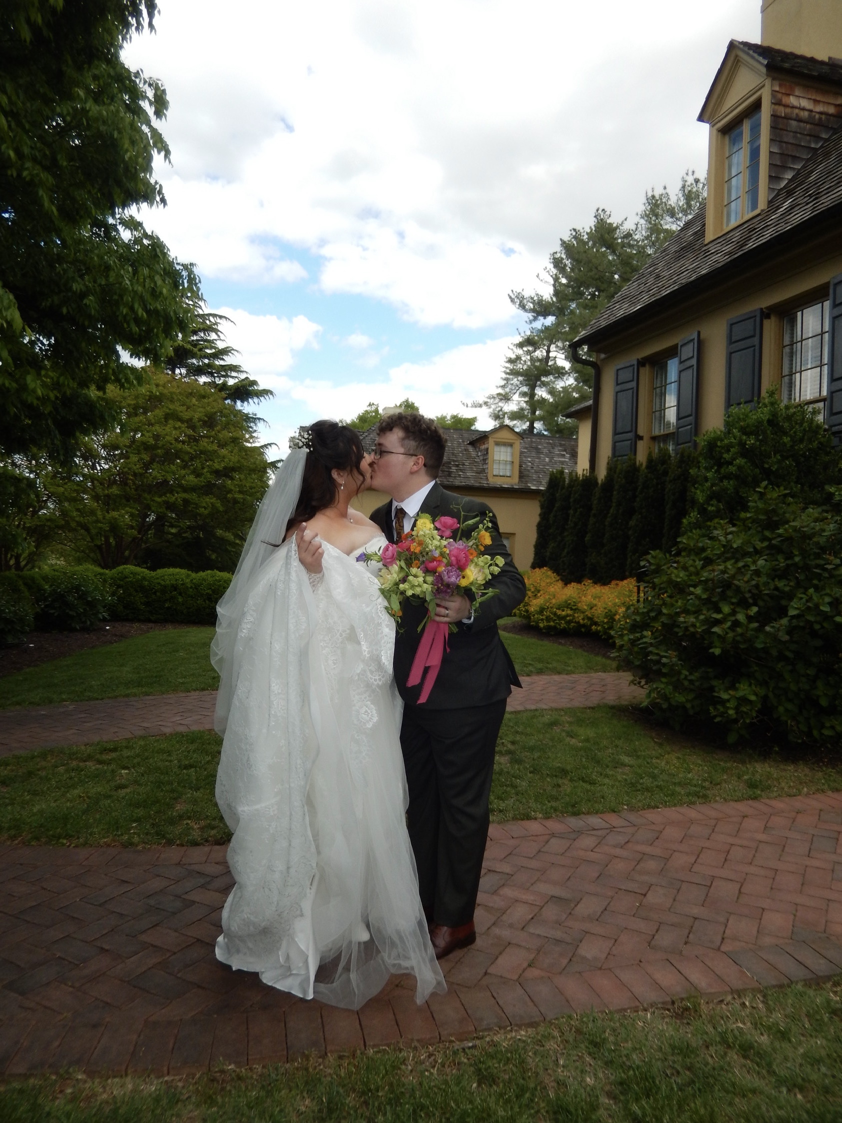 Bride and groom kissing in the garden at Belmont Manor in Elkridge, Maryland