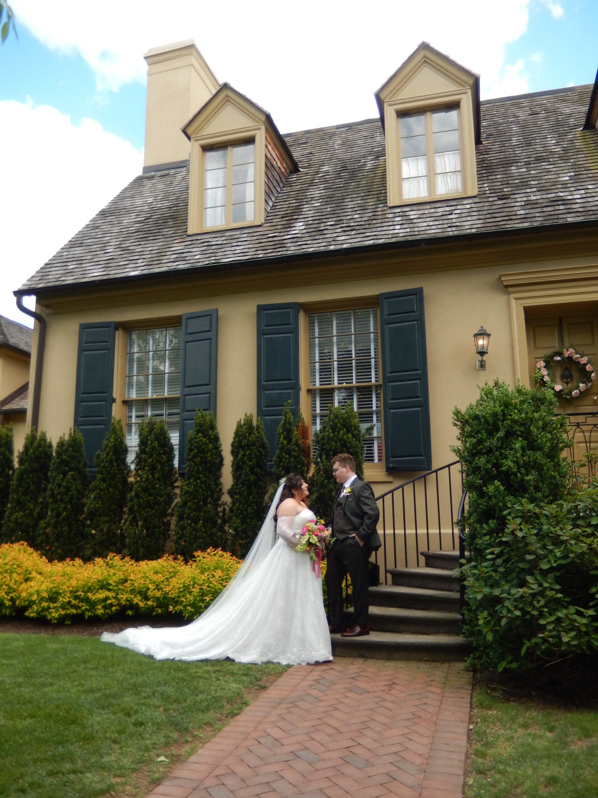 Bride and groom standing on the steps at Belmont Manor and Historic Park 